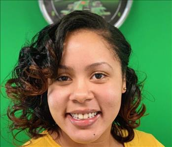 image of female smiling against a green background