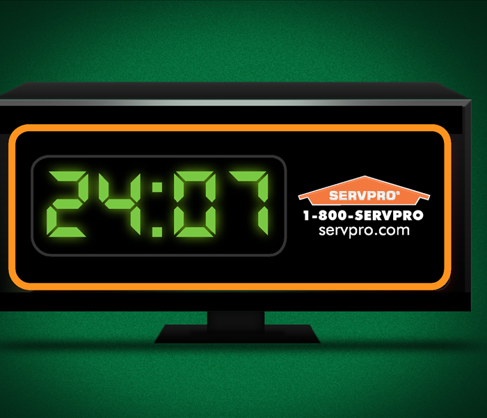 clock displaying 24: 07 and servpro contact information in the event of emergency