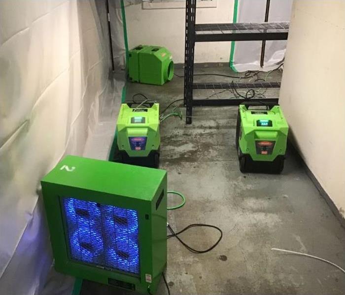 green SERVPRO drying equipment in building 